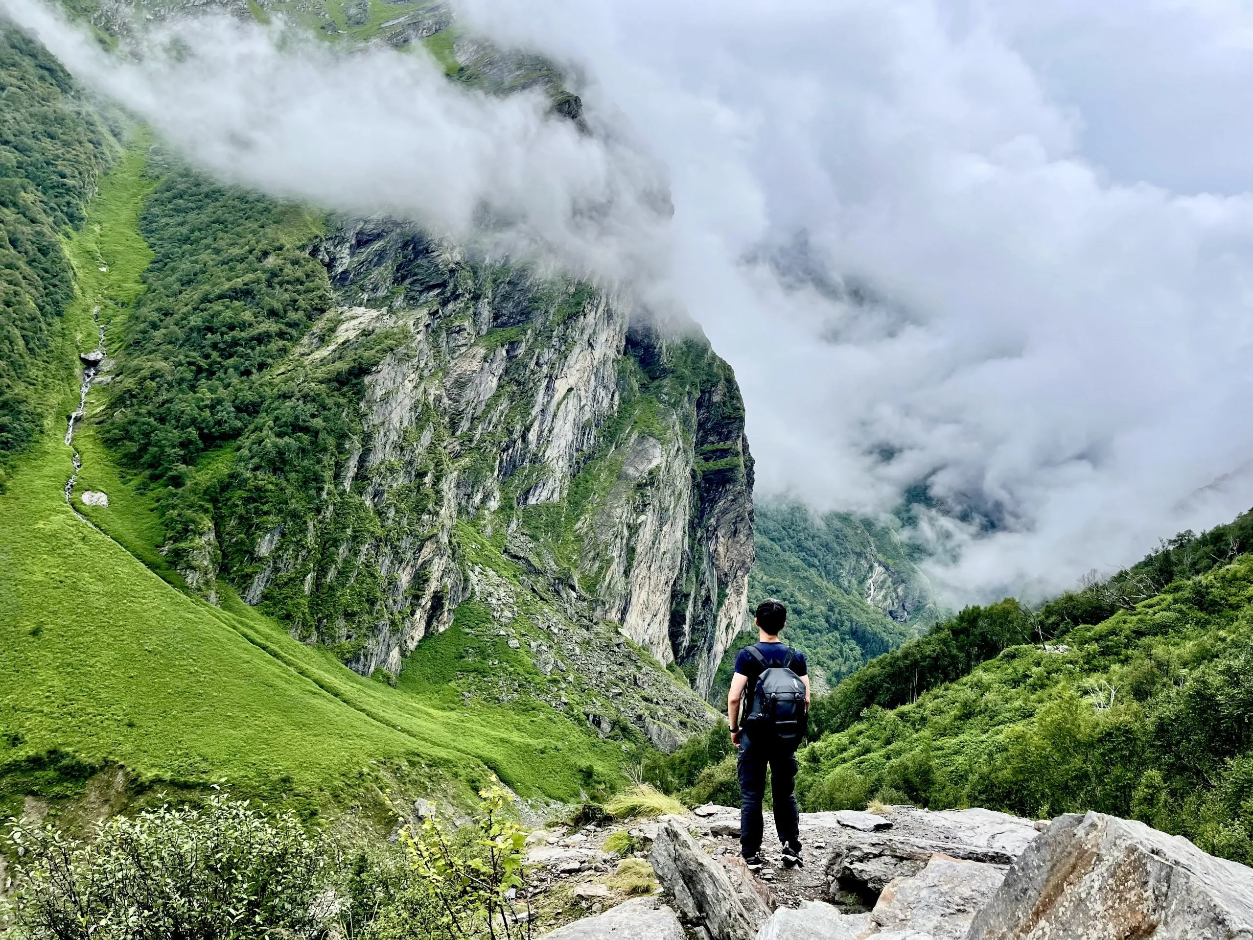 Facing the mist-covered Himalayan cliffs